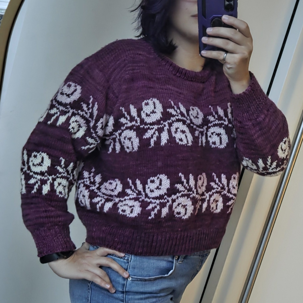 Abigail in a hand-knit purple floral sweater